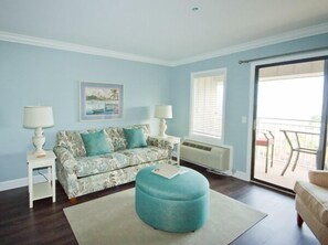 Living Room - Oceanfront Living Room Area has sliding door access to the Pool/Ocean front Balcony. Upscale furnishings and a wall mounted flat screen television complete the space.