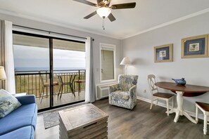 Living /dining area - Great view onto the oceanfront balcony from this newly painted villa.  New window treatments also.
