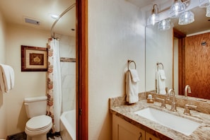 The second bedroom shares a bathroom with a bathtub and shower combination and one sink vanity.