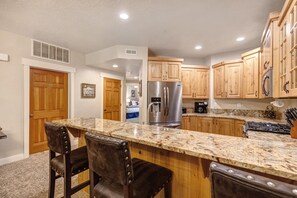 Town Pointe A102 has a gorgeous kitchen with warm wood cabinets and granite counter tops.