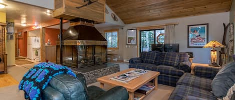 Living Room with four sided Glass Fireplace with Gas Log Lighter