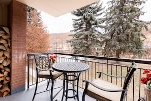 Private patio with bistro table and chairs overlooking the creek trail