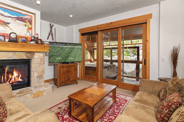 Town Pointe C302 has a cozy living room with fireplace and flat screen TV.