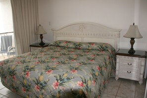 King bed with Beach view from floor to ceiling patio door onto balcony