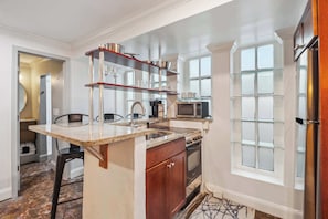 Modern Kitchenette & Bar area. Kitchenette features a smaller size Range & cooktop, microwave, Full sized Fridge, Toaster Oven, and Keurig Coffee Maker (pods included)!