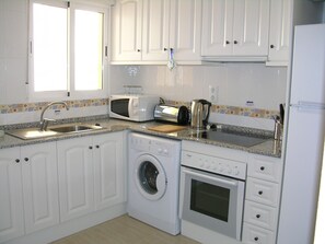The kitchen is fully equipped with oven, hob, microwave and washing machine.