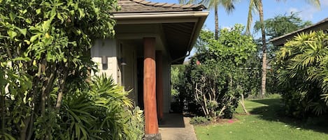 Walkway to house, 2-car garage on left (behind greenery). 