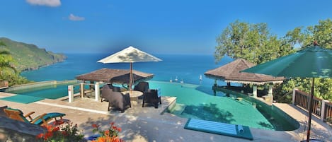 The coral stone pool deck has plenty of loungers, parasols and sun mats