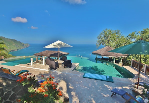 The coral stone pool deck has plenty of loungers, parasols and sun mats