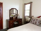 Air conditioned master bedroom with queen size bed, dressing table/drawers