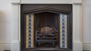Original Victorian features populate the flat, including these antique tiles.