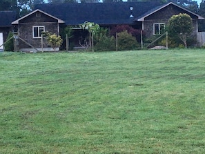 View of front of house from road across front field.