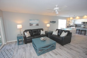 Relax after a Day at The Beach in the Spacious Living Room featuring Leather Sofas and a Large Flat Screen TV