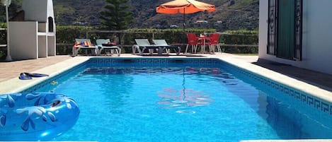 Swimming pool with countryside views.