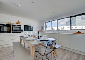 The well-designed kitchen area has been fitted using high quality contemporary designed units