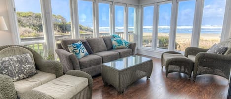 A window lined sun-room is perfect for watching waves, and whales