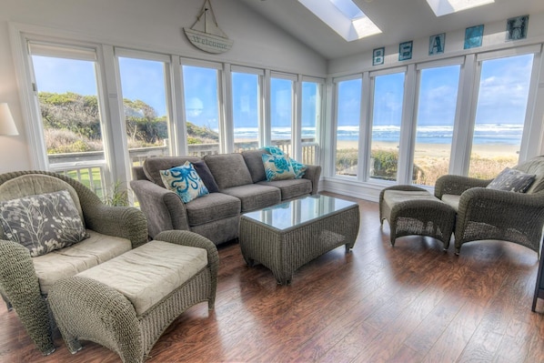 A window lined sun-room is perfect for watching waves, and whales