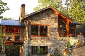 Front View of house with poplar siding 
and porches on right and left side
