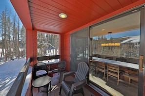 Covered patio with propane grill and outdoor seating