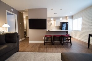 55 INCH TV, BAR AREA W/4 BAR STOOLS