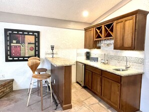 Wet bar area with seating