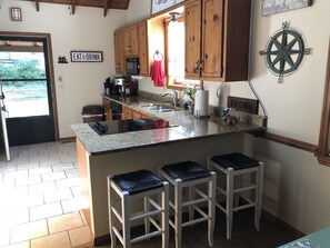 Kitchen counter has three bar stools