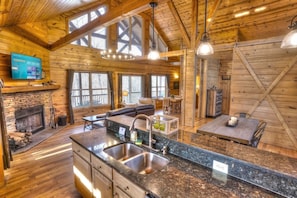 Kitchen Open to Living. Note Barn Door Shown Partially Closed
