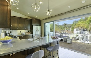 Beachy Keen Kitchen - A sliding glass partition between the kitchen and deck area extends living space.