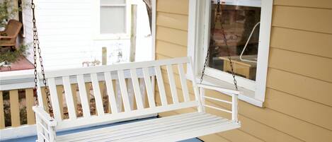 A porch swing for enjoying the quiet tree-lined street in historic OWL.