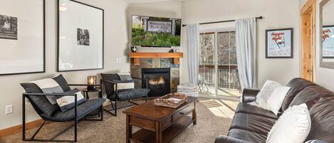 Bear Hollow Lodges 3401: An inviting living room arrangement with a gas fireplace and easy access to the outdoor balcony.