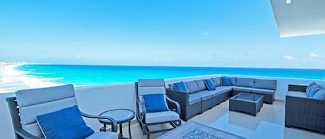 The Expansive Terrace Faces Straight out to the Ocean &amp; Includes a Large Sofa Set, 2 Sun Loungers, and a Table with Seating for 6