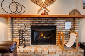 Cozy ambiance with a wood burning fireplace.