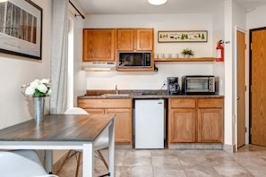 Cozy table for two beside the kitchen, perfect for intimate meals.