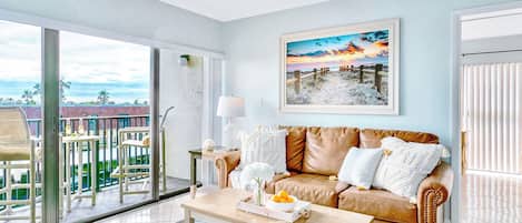 Cozy living area with a soft couch natural light and a relaxing beach vibe