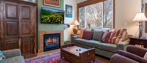 Cozy sofa set by the gas fireplace, overlooking the window and TV.