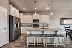 Gourmet kitchen with chrome appliances, and everything you need to feed a crowd.