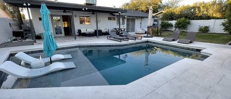 Newly remodeled resort backyard - limestone deck and pool with Baja shelf 