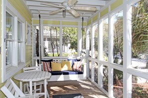 SCREENED PORCH W/BISTRO SEATING AND SWING AT ENTRANCE