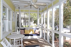 SCREENED PORCH W/BISTRO SEATING AND SWING AT ENTRANCE