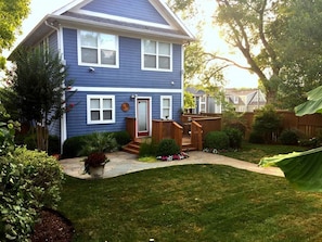 Fenced in private backyard with deck, patio, 4 burner grill, lush landscaping.