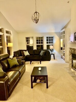 The living room is so comfortable, reclining new leather couch. 