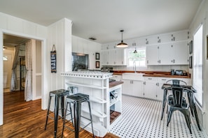 Light and airy, the kitchen opens up to the family room.