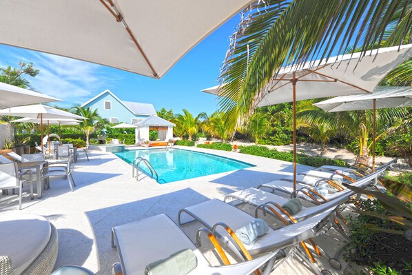 Lounge by Sea Orchard Retreat's large pool.