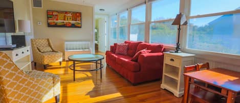 Once you enter the front door, you will find our sun room with an overstuffed sofa, arm chairs and a smart TV.
