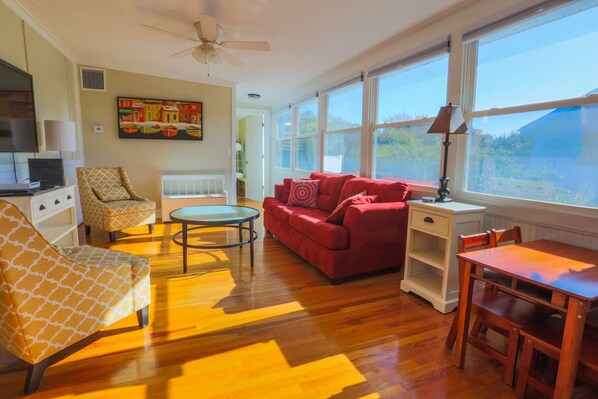 Once you enter the front door, you will find our sun room with an overstuffed sofa, arm chairs and a smart TV.