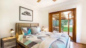 Queen bedroom with doors opening onto patio