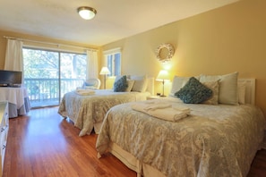 This bedroom features two queen beds, a private balcony and an en suite bathroom.