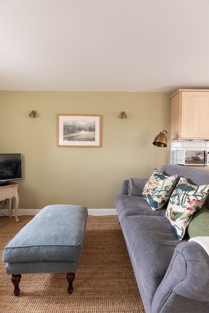 Woodman's Cottage - sitting room with double sofa and TV