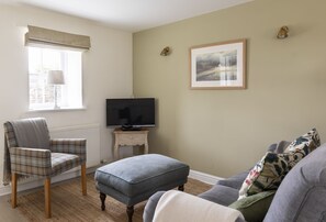 Woodman's Cottage - sitting room with double sofa, armchair and TV