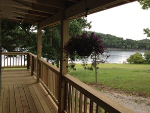 Side deck with entrance into sunroom.  The deck stairs have four wide steps.